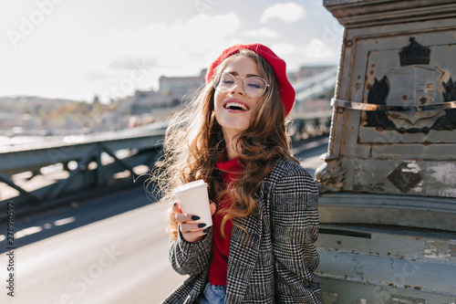 Photography Interested caucasian girl in vintage outfit drinking coffee during trip around Europe