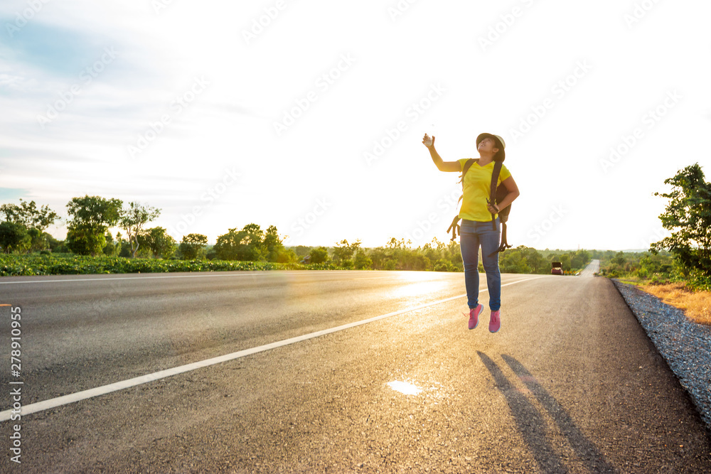 Happy woman jump At the time of the sun set Concept of vacation and travel Happy woman jump At the time of the sun set Concept of vacation and travel