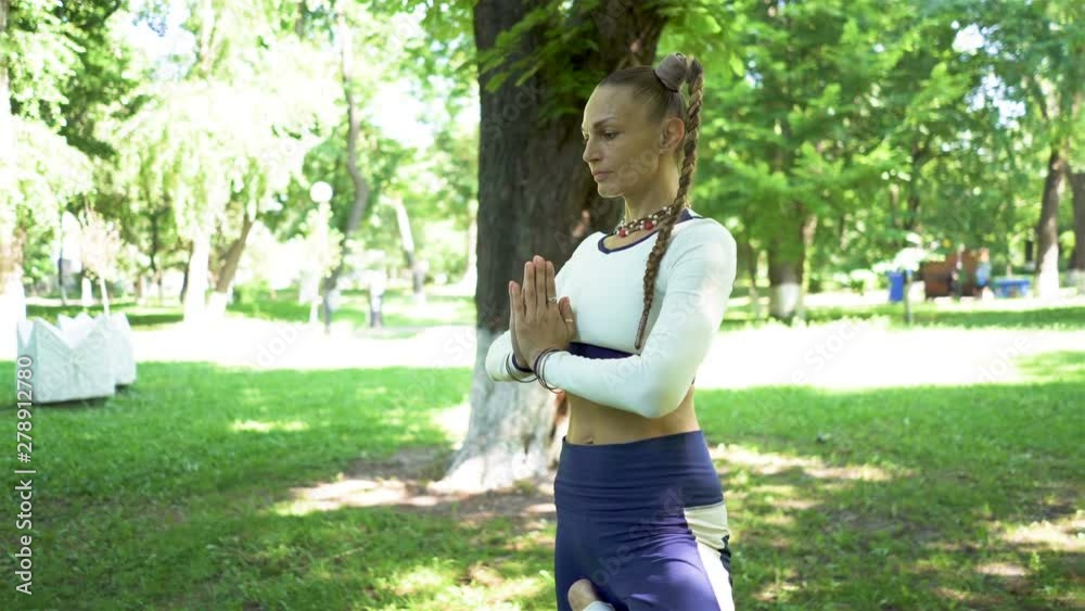 4K. Contemporary yoga meditation exercises of adult woman in city park. Asana, steady shot 4K. Contemporary yoga meditation exercises of adult woman in city park. Asana, steady shot