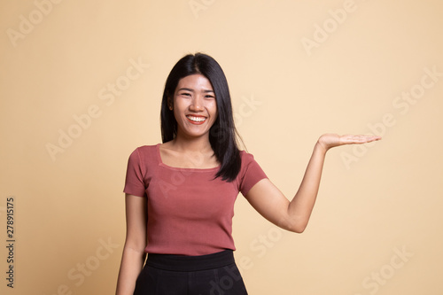 Beautiful young Asian woman show palm hand.
