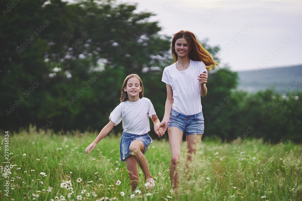 mother and daughter running in the field mother and daughter running in the field