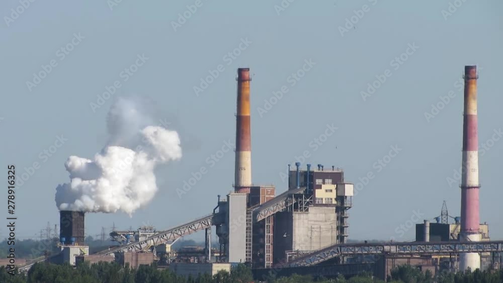Air pollutants emissions – large chimney smoking stack. Toxic smoke of air pollutants, released into the atmosphere by large chimney stack, pollutes the environment, causing the greenhouse effect. Air pollutants emissions – large chimney smoking stack. Toxic smoke of air pollutants, released into the atmosphere by large chimney stack, pollutes the environment, causing the greenhouse effect.