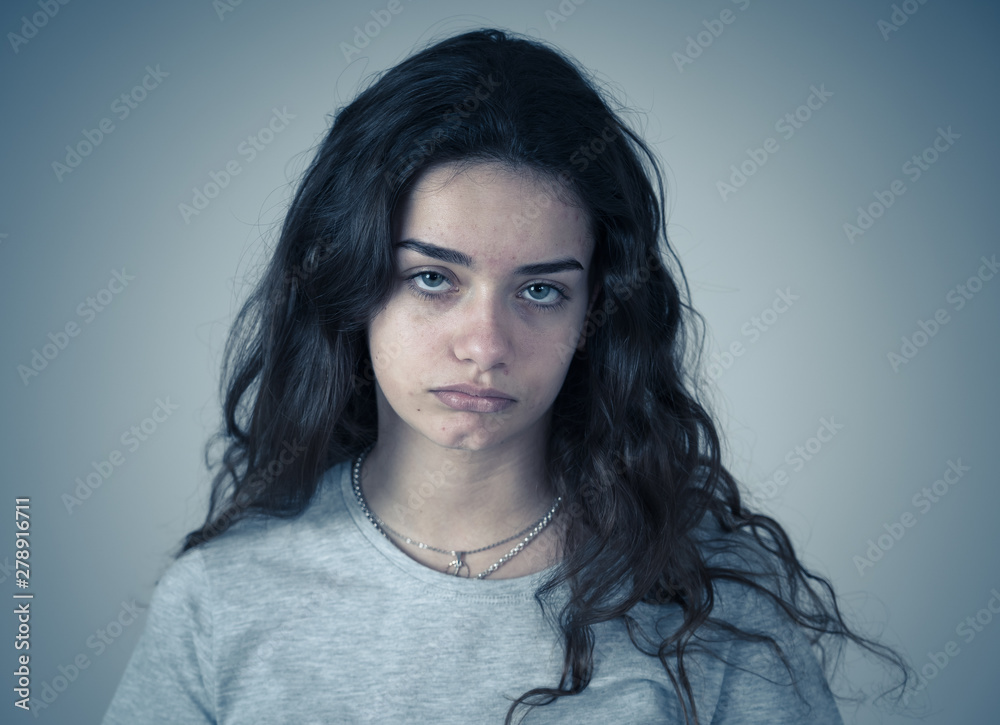 Human expressions and emotions. Young sad teenager woman looking depressed and hopeless.
