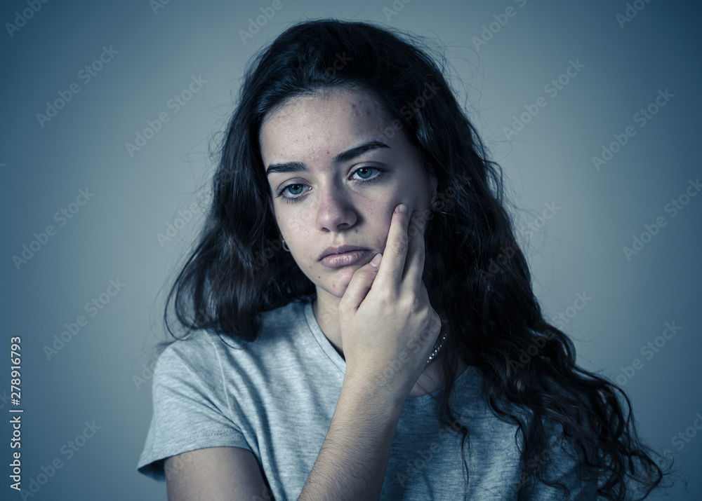 Close up portrait of teenager female suffering depression. Sad face, unhappiness human emotion.
