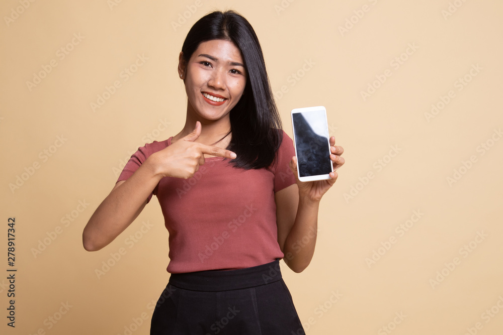 Young Asian woman point to mobile phone. Young Asian woman point to mobile phone.