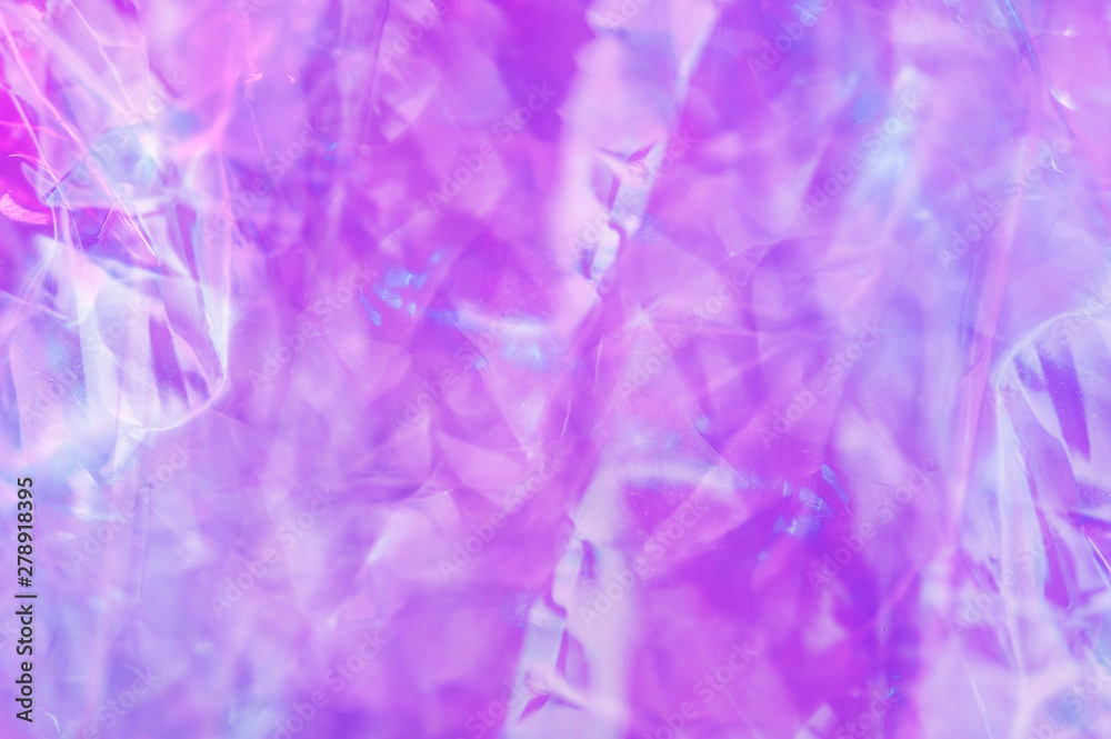 Holographic background in the style of the 80-90s. Real texture of cellophane film in bright acid colors. Holographic background in the style of the 80-90s. Real texture of cellophane film in bright acid colors.
