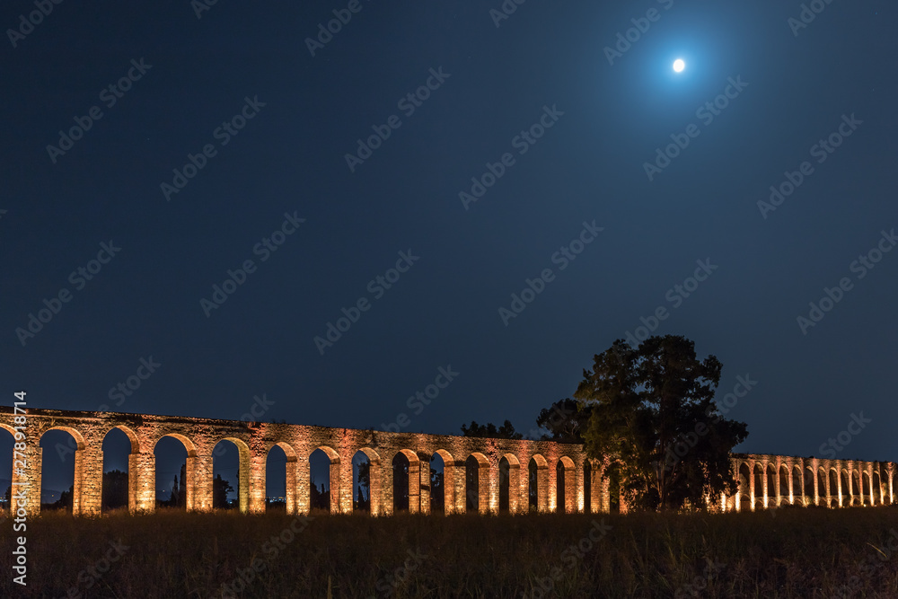 Fototapeta premium Night view of the remains of an ancient Roman aqueduct located between Acre and Nahariya in Israel