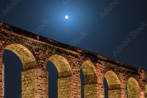 Night  view of the remains of an ancient Roman aqueduct located between Acre and Nahariya in Israel photo