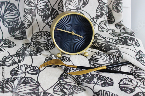 Wallpaper Mural clock with cutlery, on the background of the fabric with a gray pattern, creative background Torontodigital.ca