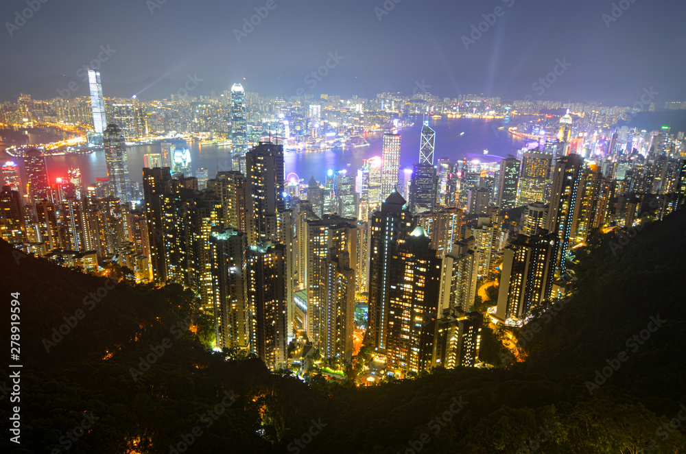Fototapeta premium Night view of modern buildings along Victoria Harbour in Hong Kong