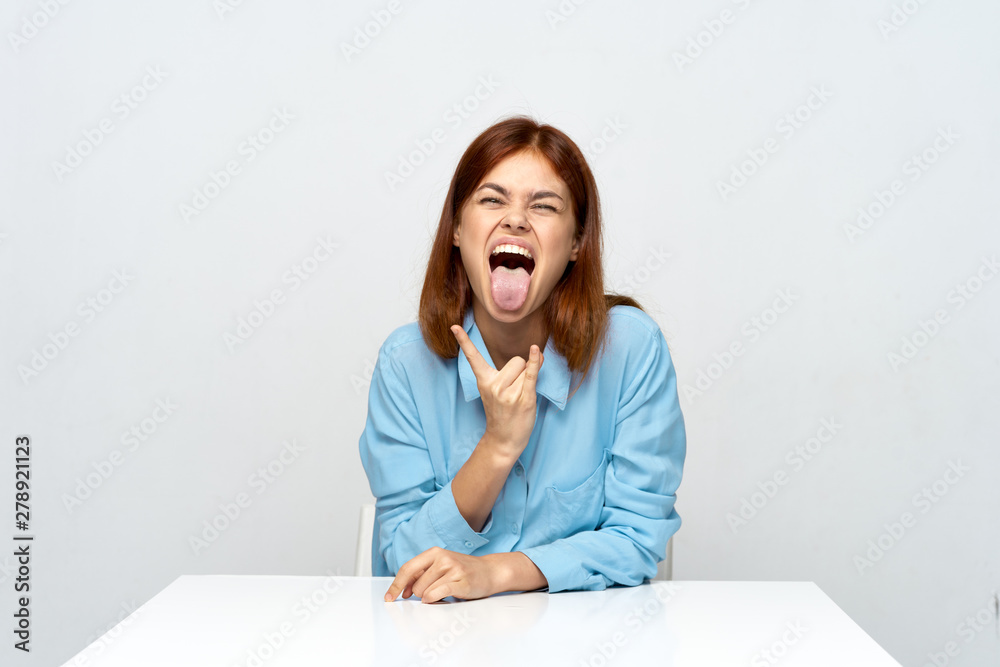 portrait of a young woman sitting at desk portrait of a young woman sitting at desk