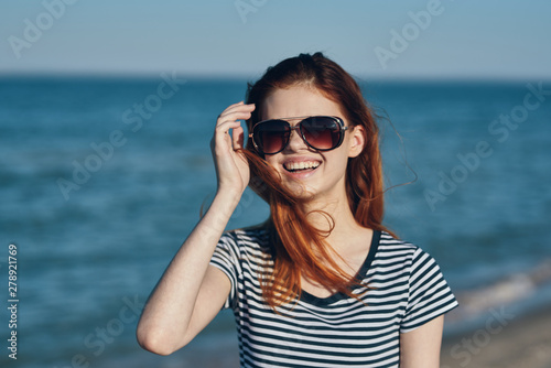 young woman with sunglasses on the beach © SHOTPRIME STUDIO