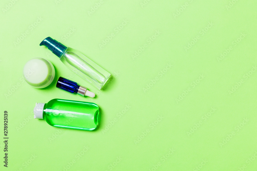Cosmetics SPA branding mock-up, top view with copy space. set of tubes and jars of cream flat lay on gren background Cosmetics SPA branding mock-up, top view with copy space. set of tubes and jars of cream flat lay on gren background
