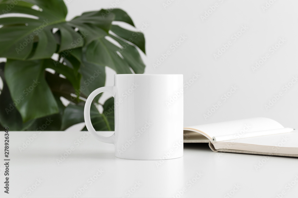 Mug mockup with workspace accessories and a monstera plant. Mug mockup with workspace accessories and a monstera plant.