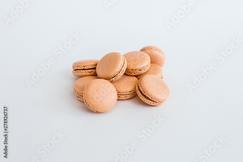Delicious almond macaroons with filling on a white background