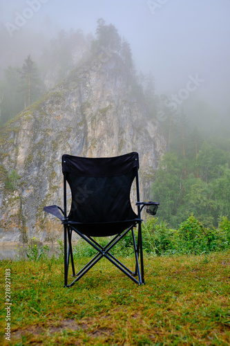 Chair outside on the mountain to observe the morning fog vertical photo