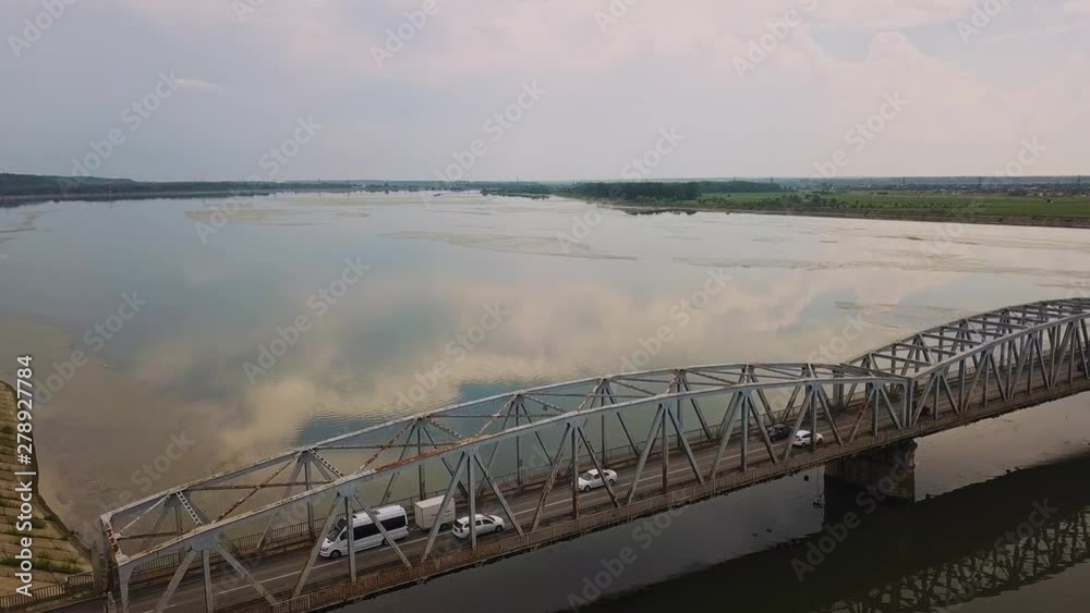 Aerial Drone Flight: View of the bridge over the river with cars. Olt river, Romania Aerial Drone Flight: View of the bridge over the river with cars. Olt river, Romania