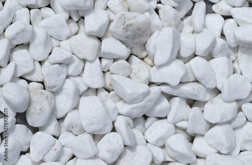 Background texture of white stone of different shapes. View from above, close-up, horizontal. Concept of design and gardening.