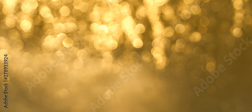Golden bokeh background close up. Abstract blurred glowing background.