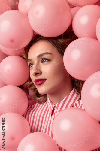 Dreamy female amidst balloons