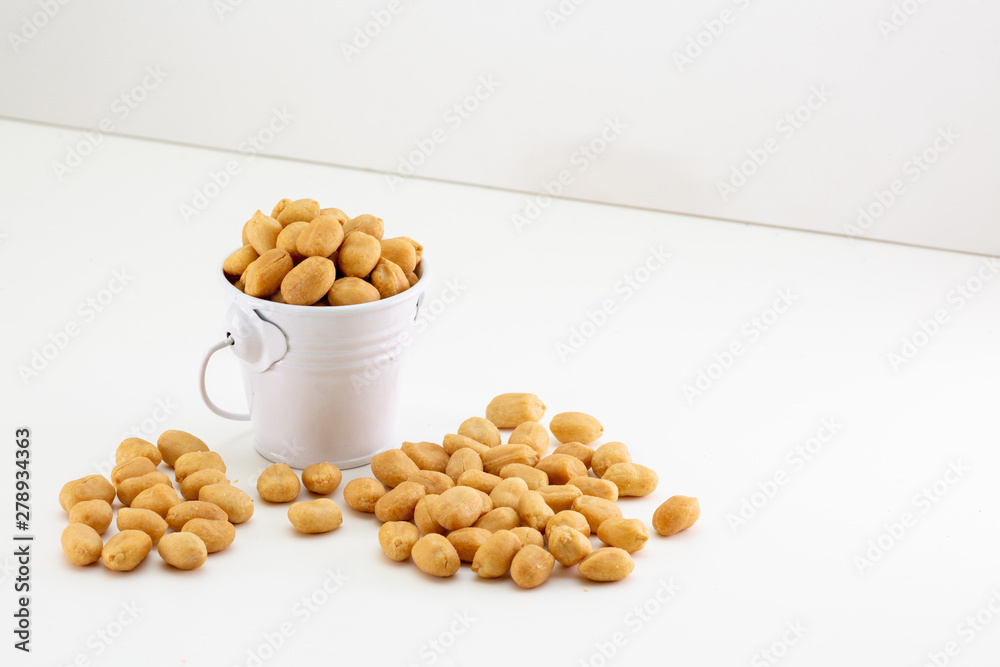 peanuts in a bowl isolated on white background peanuts in a bowl isolated on white background