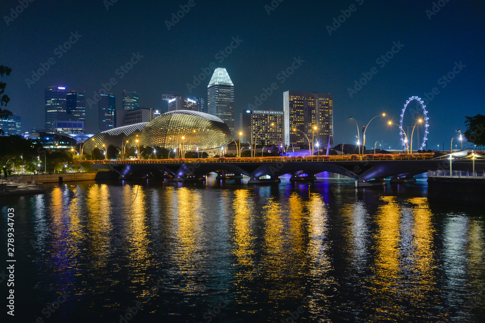 veiw of Esplanade Theatres and Esplanade Bridge with reflection at night, take a photo from Anderson Bridge in Singapore.