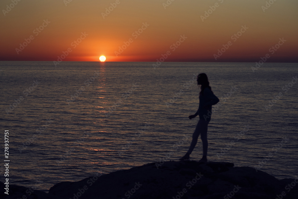 silhouette of woman at sunset