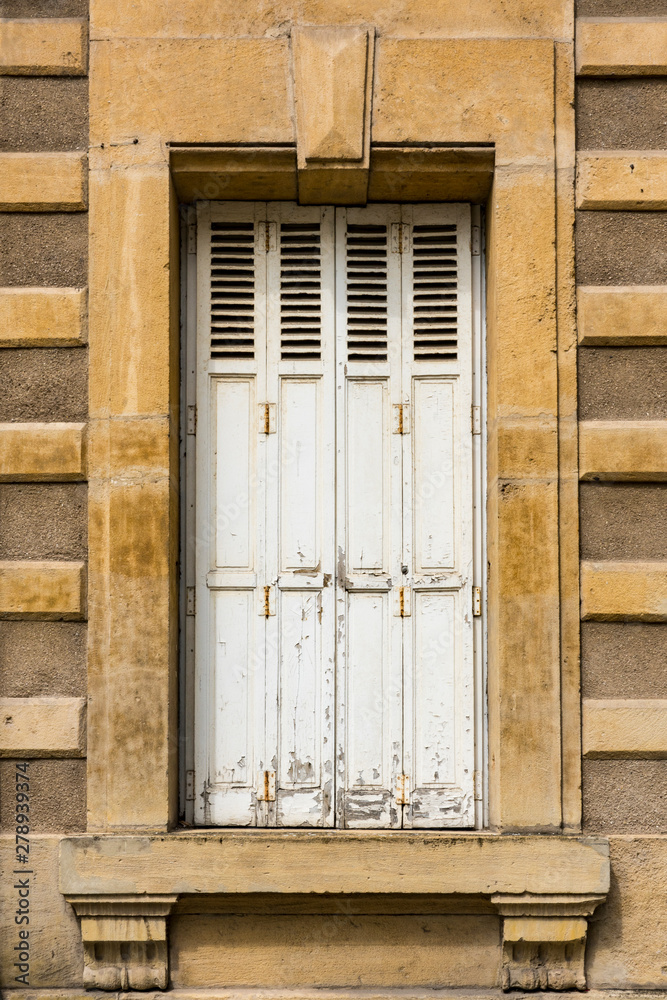 decorative window with white wooden shutters. Thionville, France decorative window with white wooden shutters. Thionville, France