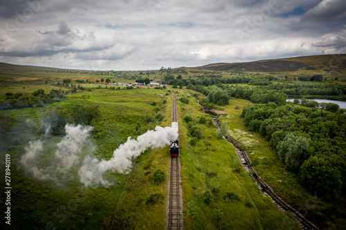 Aerial view of Landscape with steam train of the heritage railway in Blaenavon driving along Garn Lakes Local Reservce in Wales, UK