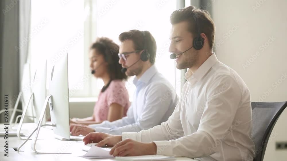 Male call center agent wear wireless headset consulting customer