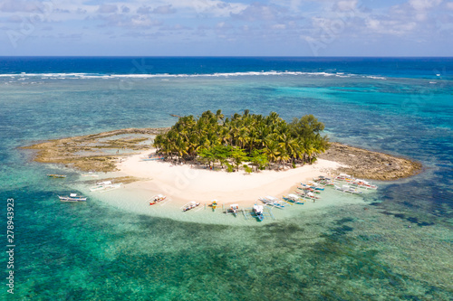 Guyam island, Siargao, Philippines. Small island with palm trees and a white sandy beach. Philippine Islands.