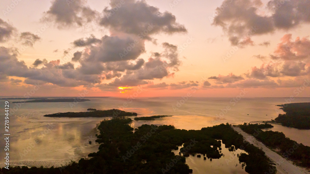 Sunset over the sea with islands, view from above. Philippine Islands at sunset. Evening sky with clouds.