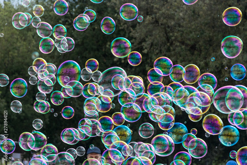Soap bubbles on green background