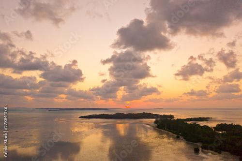 Sunset over the sea with islands, view from above. Philippine Islands at sunset. Evening sky with clouds.