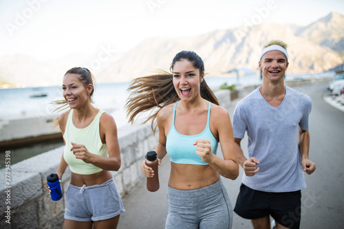 Group of young people jogging and running outdoors in nature