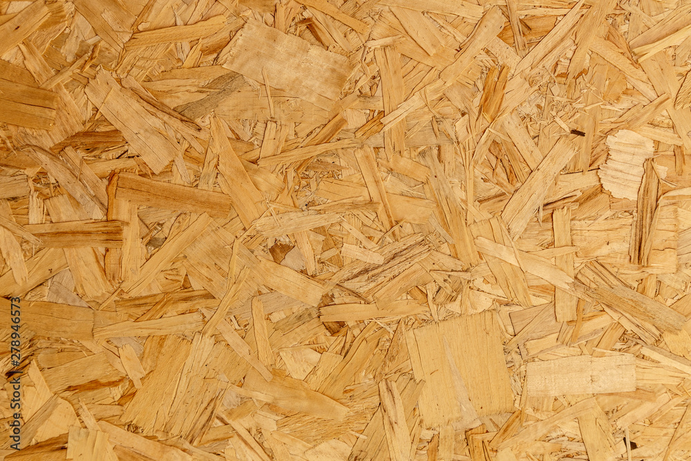 close up pressed wooden panel background texture of oriented strand board - OSB wood close up pressed wooden panel background texture of oriented strand board - OSB wood