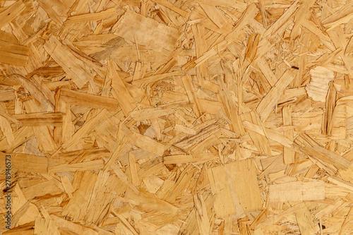 close up pressed wooden panel background texture of oriented strand board - OSB wood