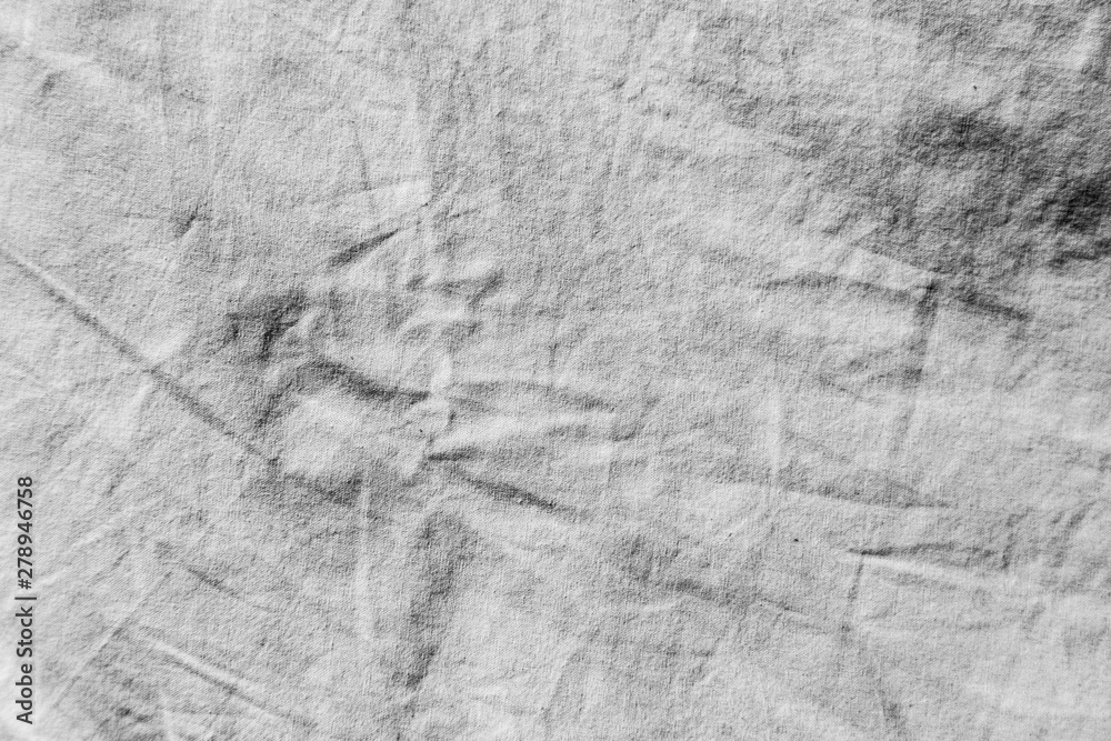 Naklejka premium Dirty white fabric background in direct sunlight with clear, deep shadows.