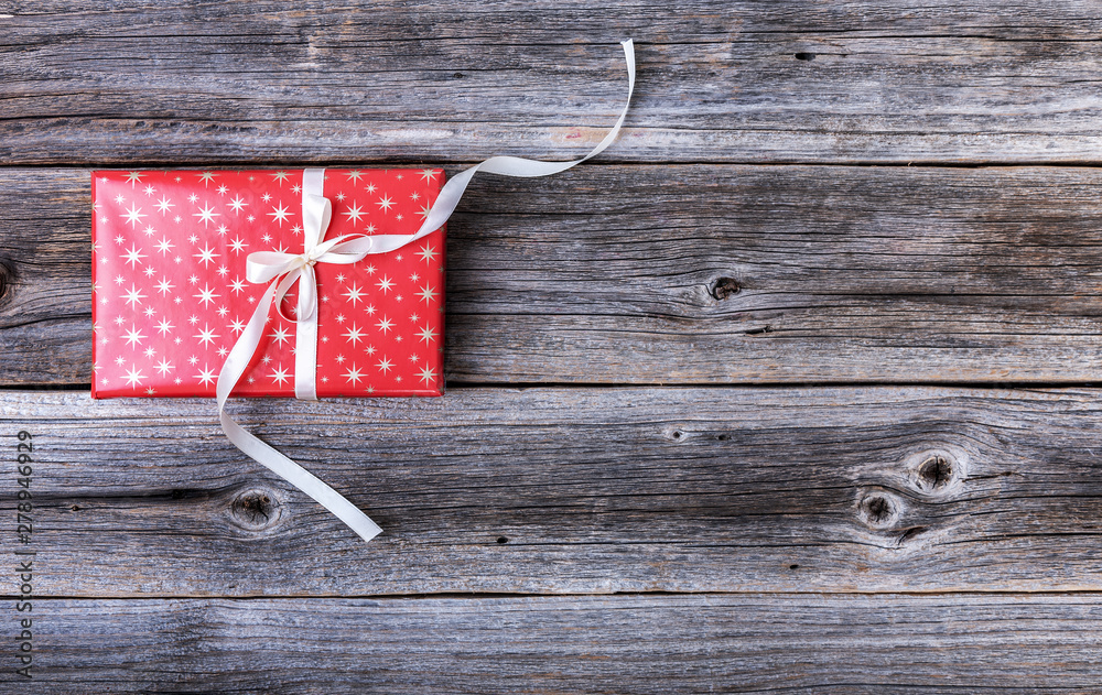 Fototapeta premium Red gift box on wooden background.