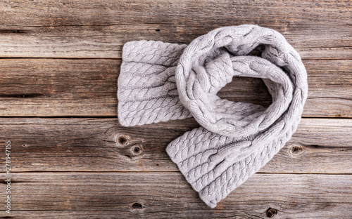 Winter scarf on a wooden background.