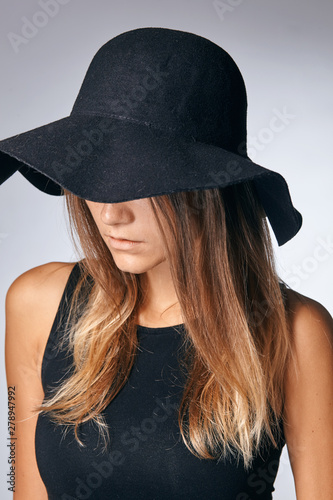 woman in hat. Retro fashion. Dark Background.
