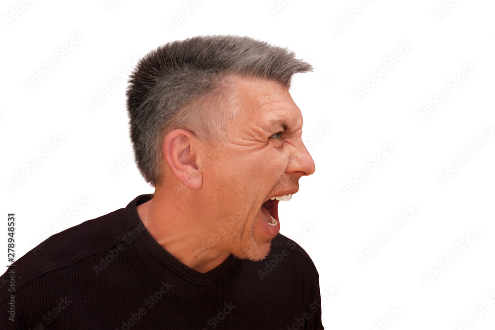Fototapeta premium Guy does not look into camera and shouts. Isolated profile portrait on white background. Emotion and gesture of middle aged unshaven shaggy man in black t-shirt. Angry face and aggressive view
