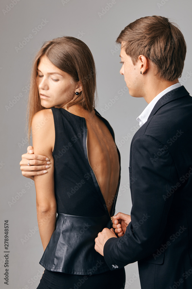 Man zipping up girlfriend's dress. man helping woman zip up dress. Gentleman behavior, Care concept. Man zipping up girlfriend's dress. man helping woman zip up dress. Gentleman behavior, Care concept.