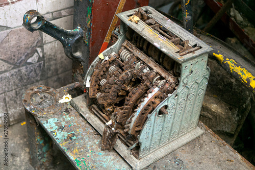 old mechanical computing machine. Ancient calculator. Rusty mechanism.