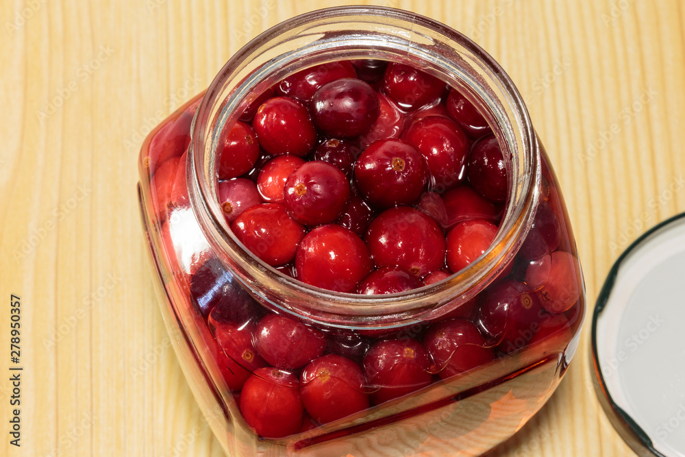 Cranberry beverage in a glass jar. Soft drinks for children. Cranberry beverage in a glass jar. Soft drinks for children.