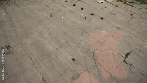 One person lying on the pavement, view from a height.