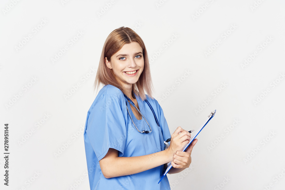 young female doctor writing on clipboard young female doctor writing on clipboard