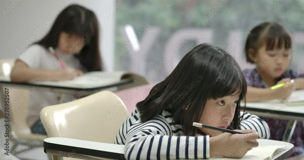 Girl falling asleep because of too much studying. Asian school girl sleeping on desk in the classroom. Girl falling asleep because of too much studying. Asian school girl sleeping on desk in the classroom.