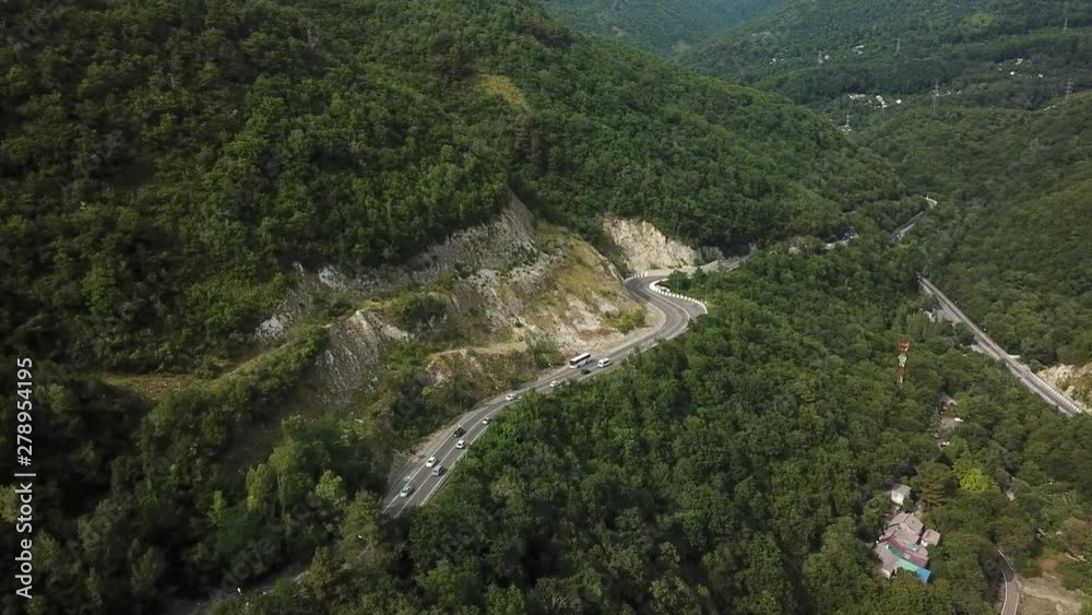 Drones Eye View - winding road from above of the high mountain pass to Sochi, Russia. Drones Eye View - winding road from above of the high mountain pass to Sochi, Russia.