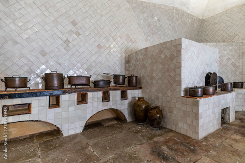 Old kitchen interior full of copper pots photo